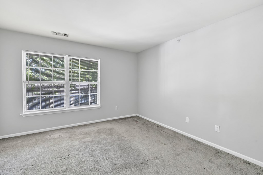 A room with a window and a white ceiling.
