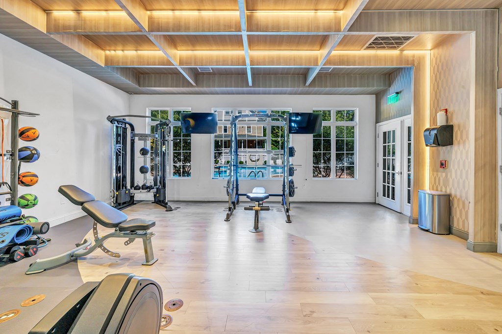 A gym with a variety of equipment including weights and cardio machines.