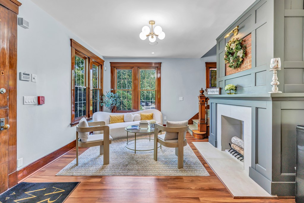A living room with a fireplace and a dining table.