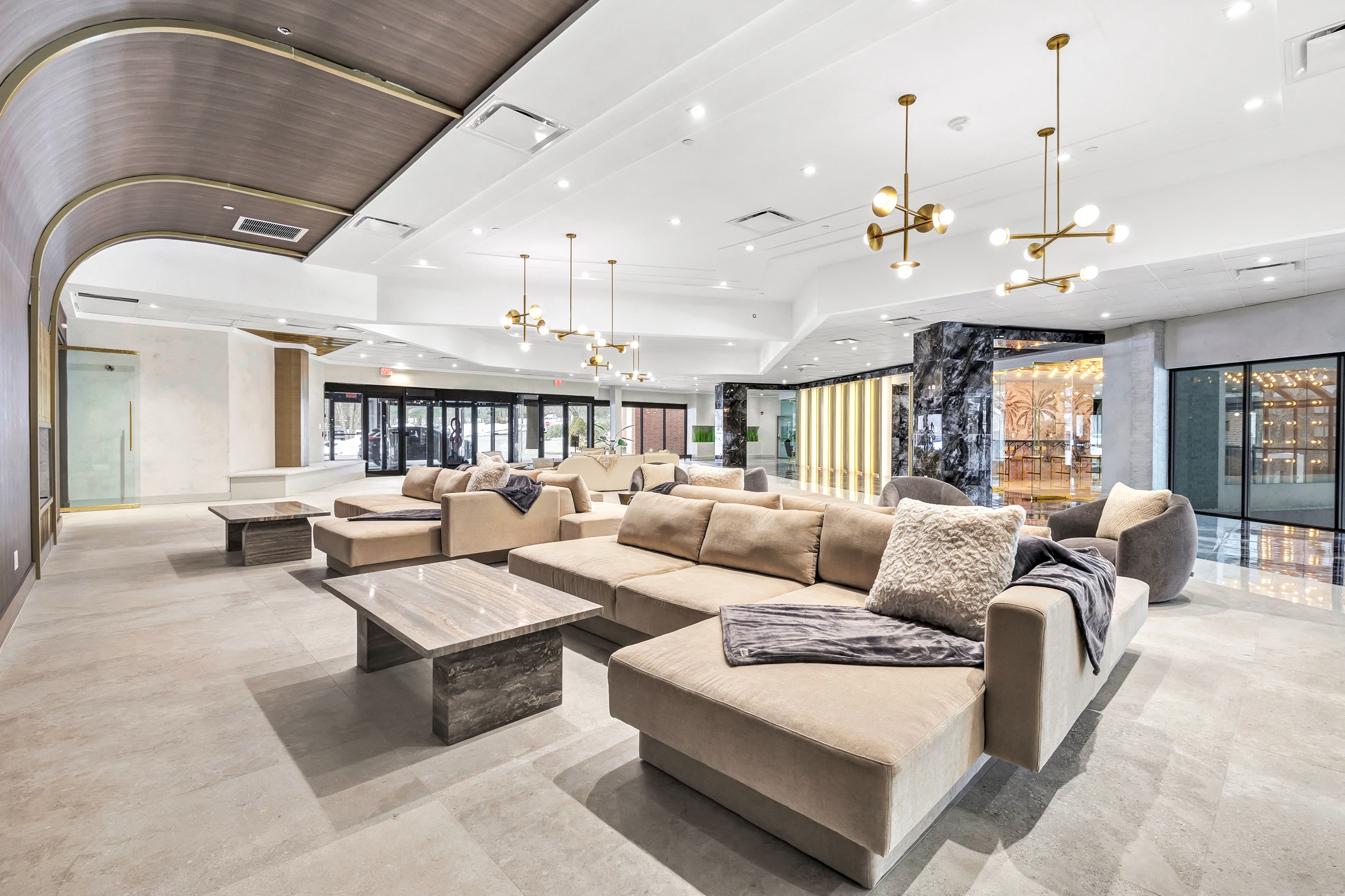 the lobby of a building with couches and tables