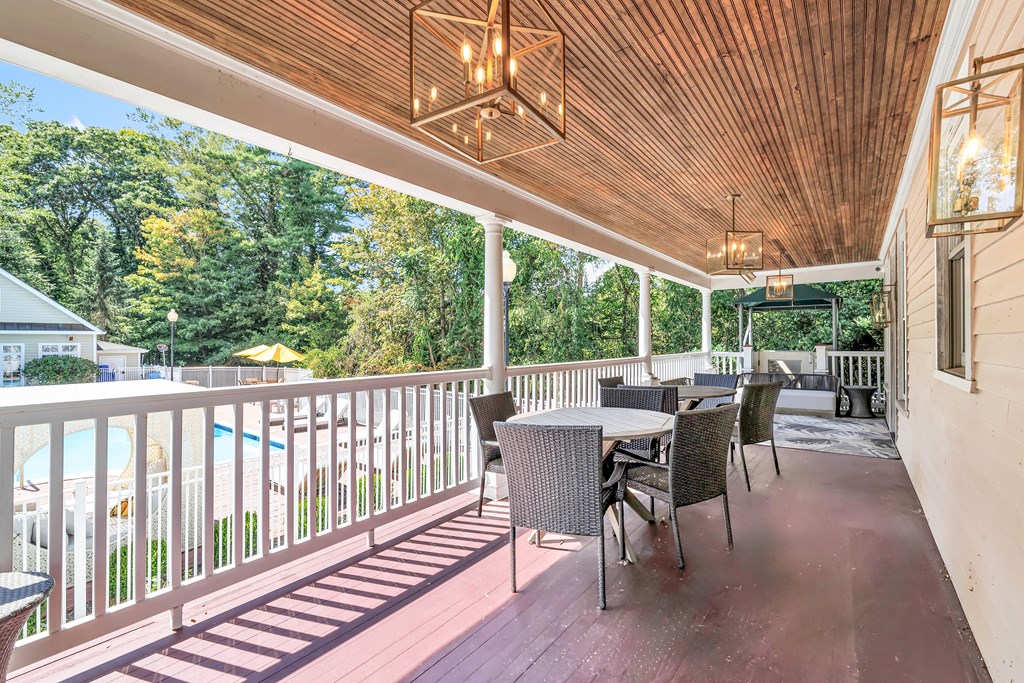 A wooden deck with a table and chairs.