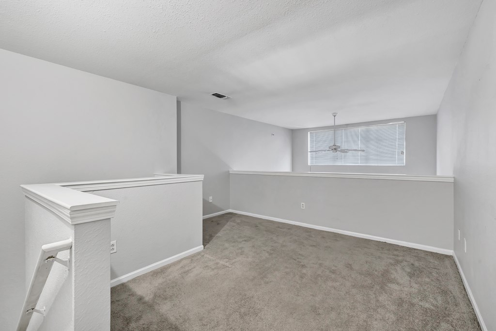 A room with white walls and a carpeted floor.