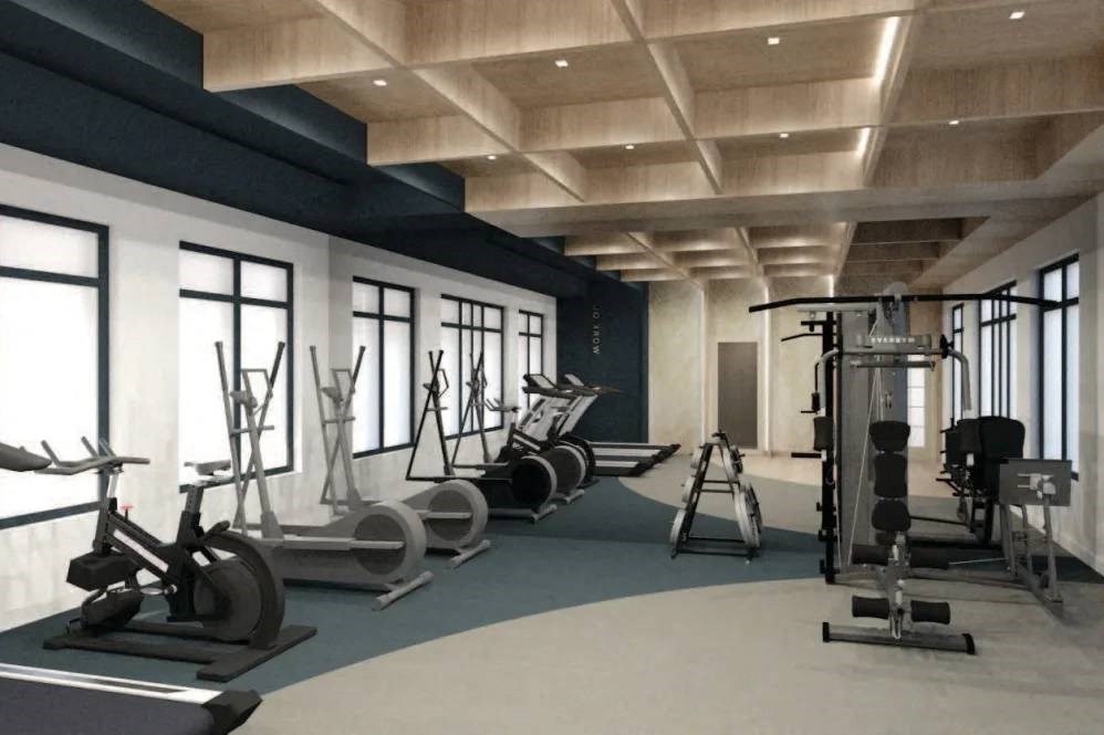 a gym with a lot of equipment and windows