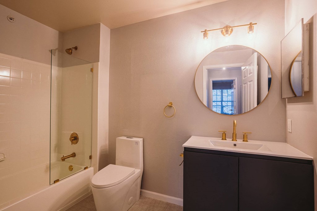 a bathroom with a toilet sink and a mirror