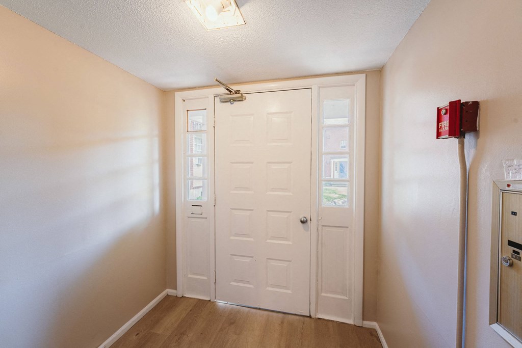 an empty room with a white door and a refrigerator at BAY SHORE APARTMENTS, EAST HAVEN, 06512