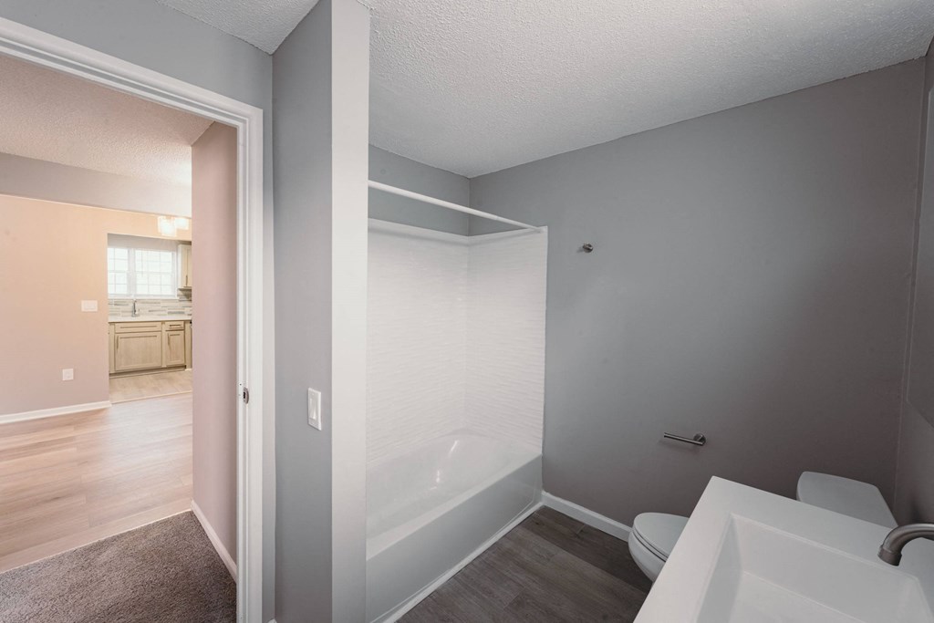 a bathroom with a tub and a sink and a mirror at BAY SHORE APARTMENTS, EAST HAVEN, CT, 06512