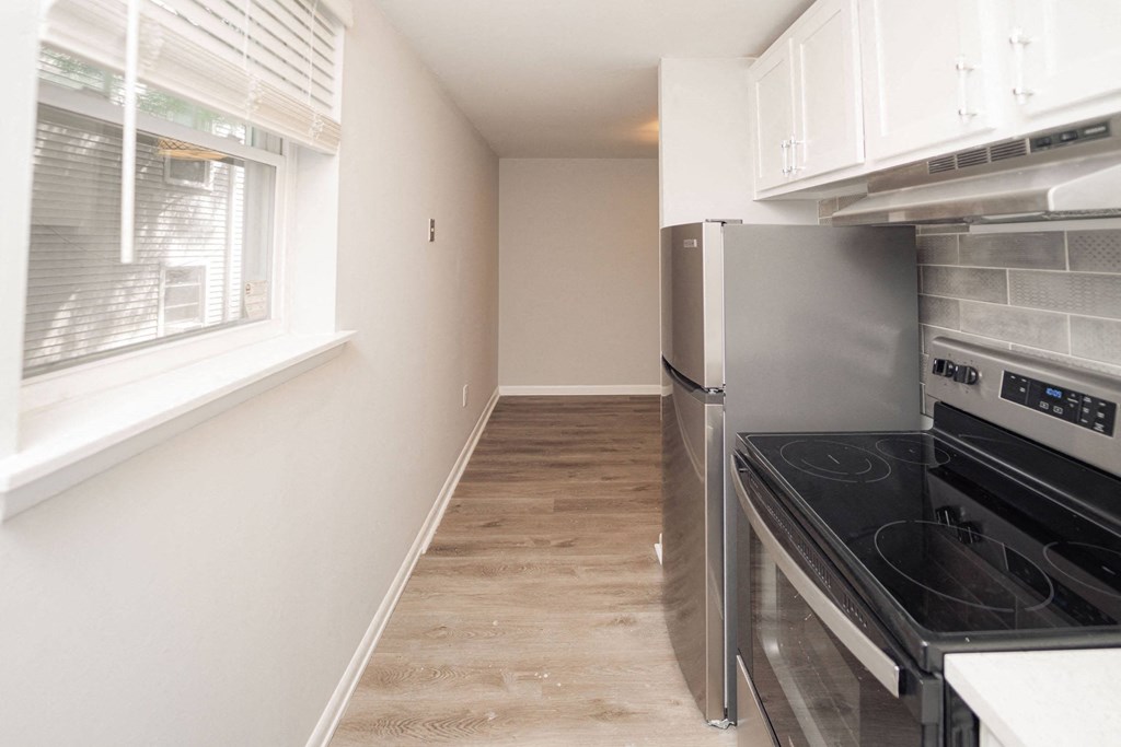 a renovated kitchen with stainless steel appliances and a window