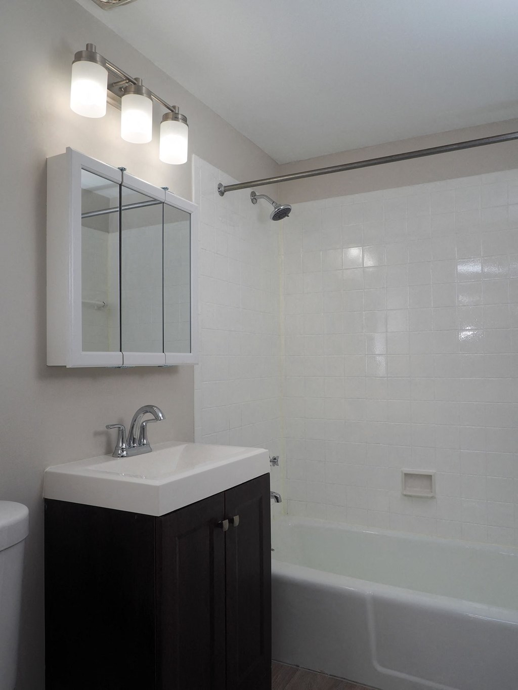 a bathroom with a sink and a tub and a mirror