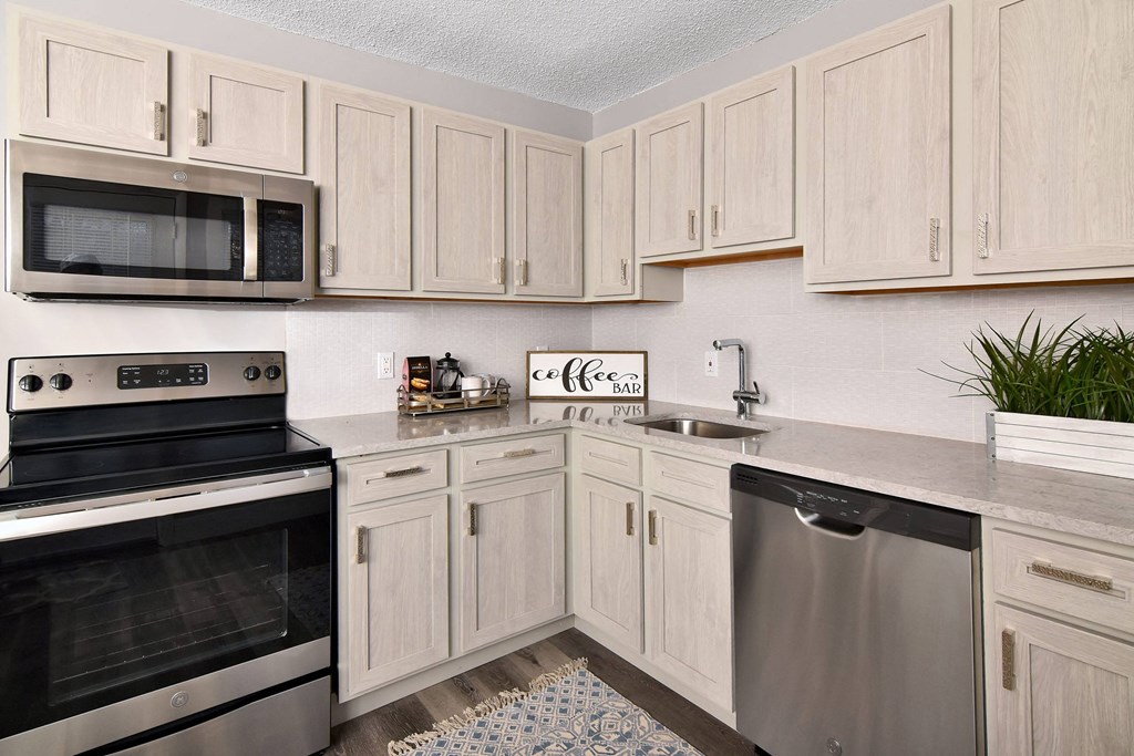 a kitchen with stainless steel appliances and white cabinets at Encore 99, East Haven, CT, 06512