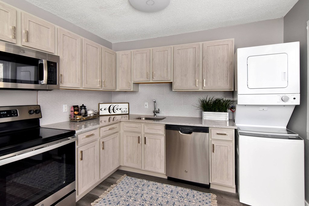 a kitchen with white appliances and wooden cabinets at Encore 99, East Haven, CT, 06512