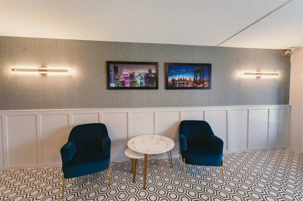 a living room with blue chairs and a white table