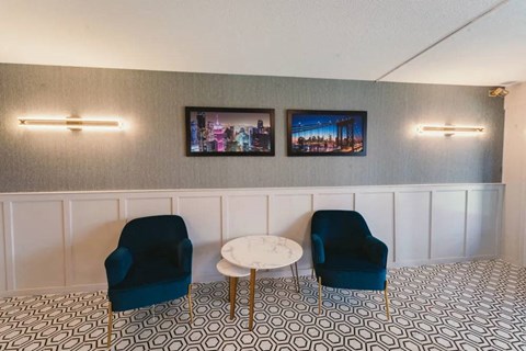 a living room with blue chairs and a white table at Five High, West Hartford