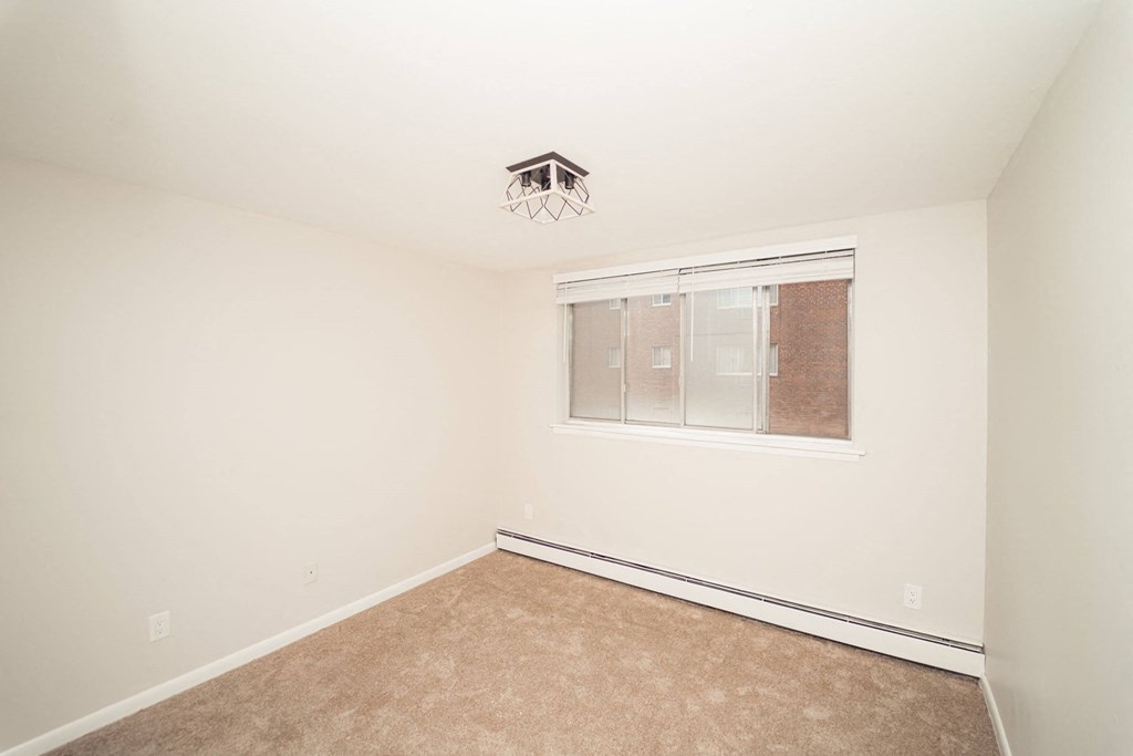a bedroom with white walls and a window at Five High, Connecticut, 06119