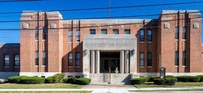 a large brick building with a street in front of it