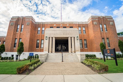 a large brick building with stairs in front of it