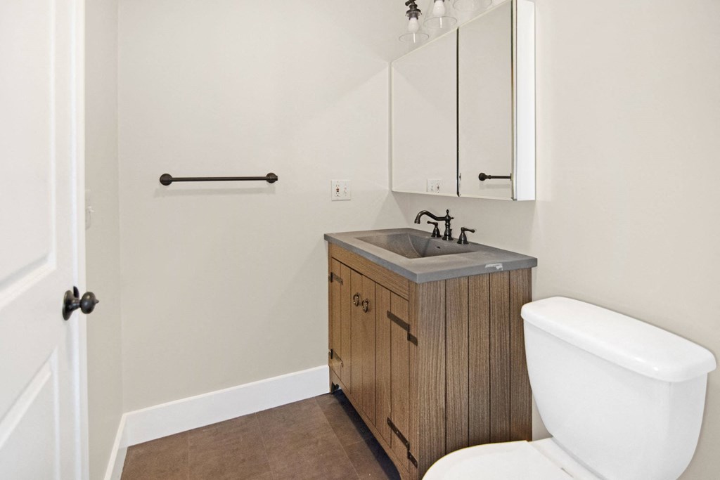 a bathroom with a toilet and a sink and a mirror