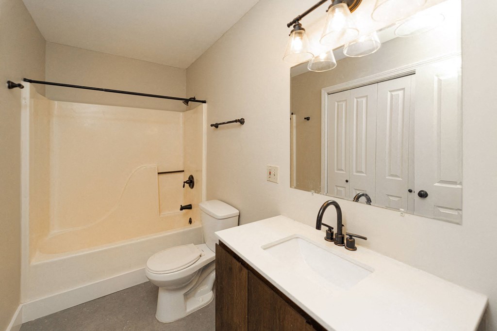 a bathroom with a sink and a toilet and a shower