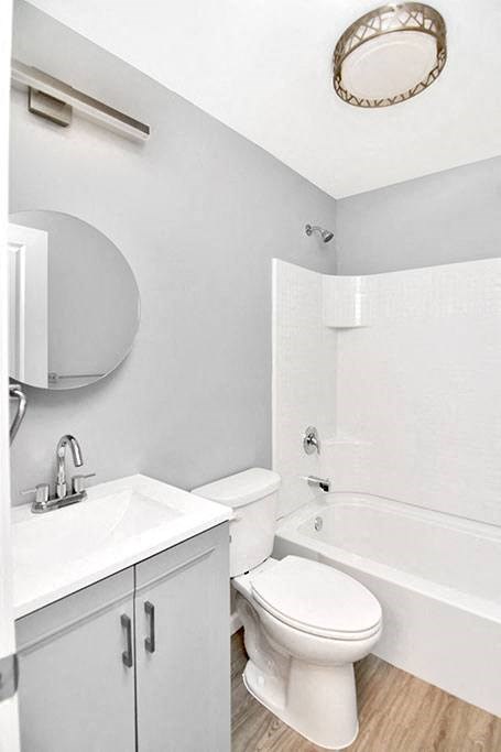a white bathroom with a toilet and a sink