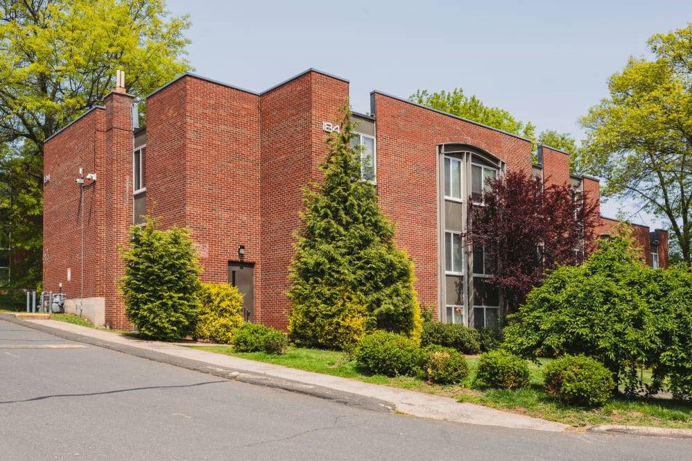 a red brick building with a street in front of it