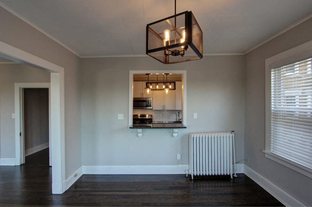 a living room with a heater and a window