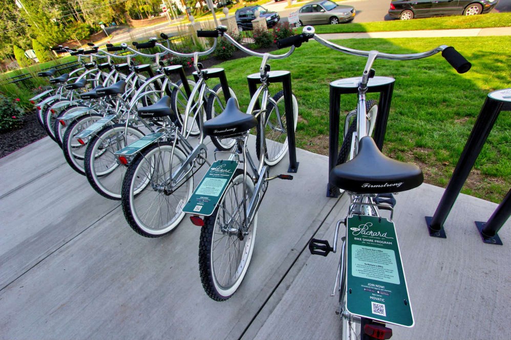a row of bikes parked on a porch