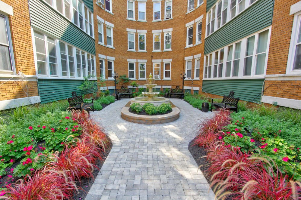 a courtyard with a fountain in the middle of a building