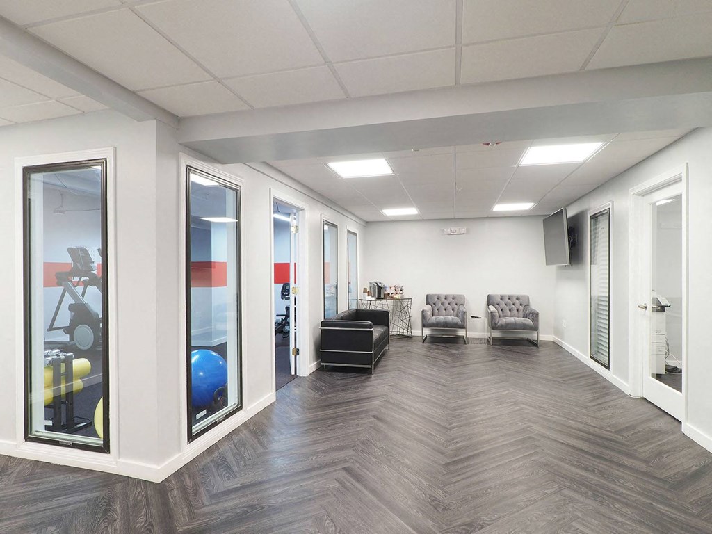a waiting room at a hospital with windows and furniture