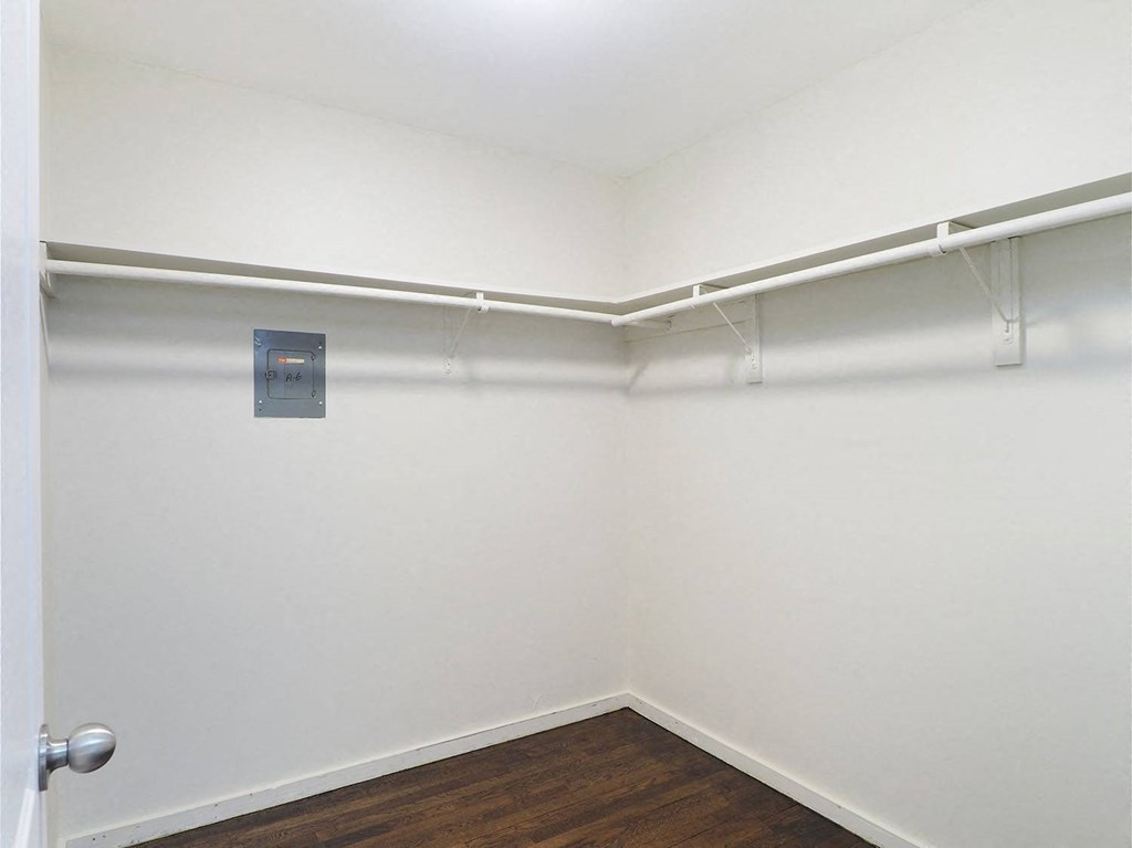 an empty room with white walls and a hanger on the wall
