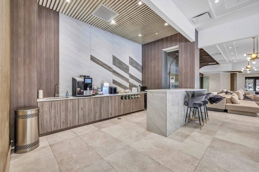 the lobby of a hotel with a bar and a couch