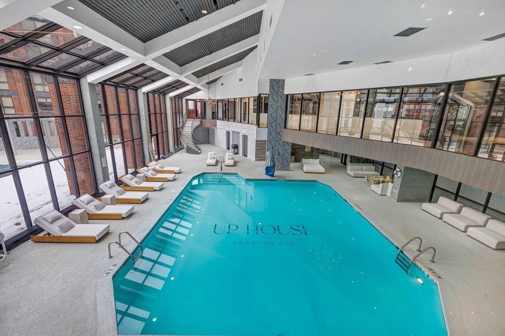 the pool at upholstered lounge chairs around a large pool in the middle