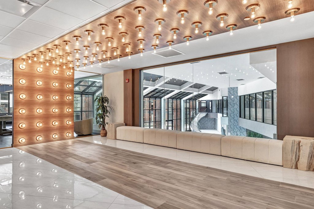 a lobby with a couch and a large mirror