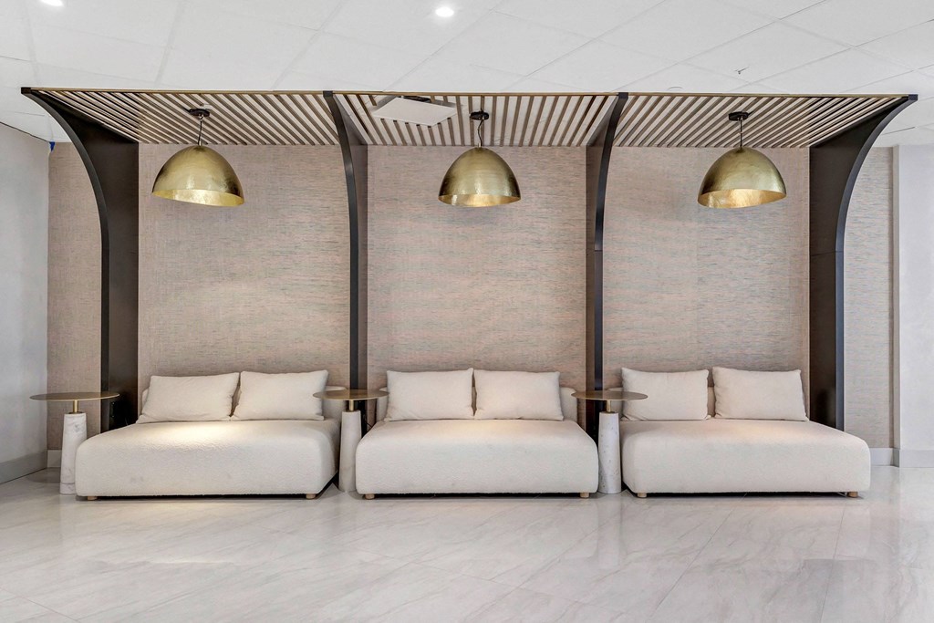 a seating area with two couches and three lamps