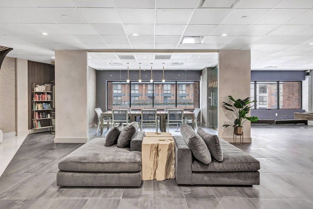 the lobby of an office building with couches and a table