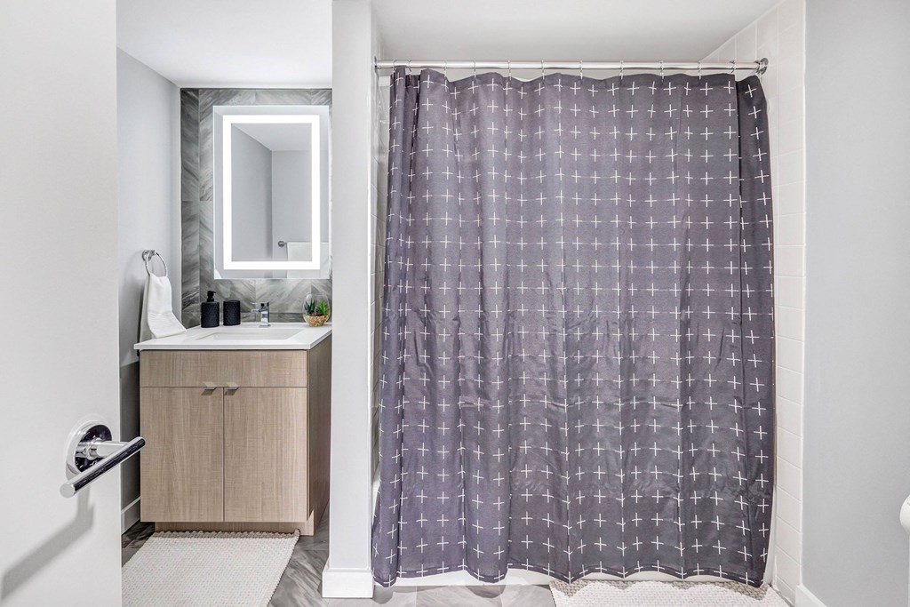 a bathroom with a shower curtain and a sink