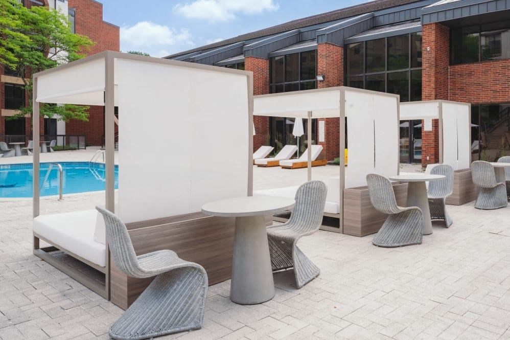 a patio with tables and chairs and a pool