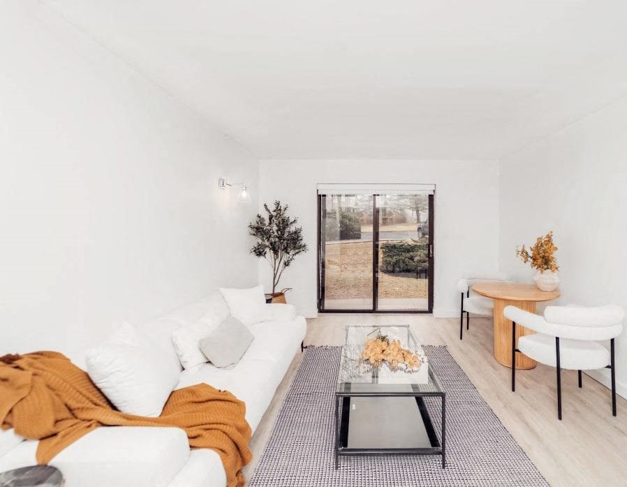 a living room with a white couch and a table