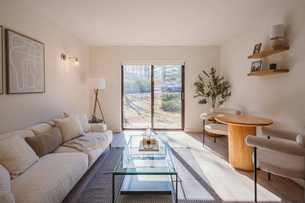 a living room with a couch and a glass table