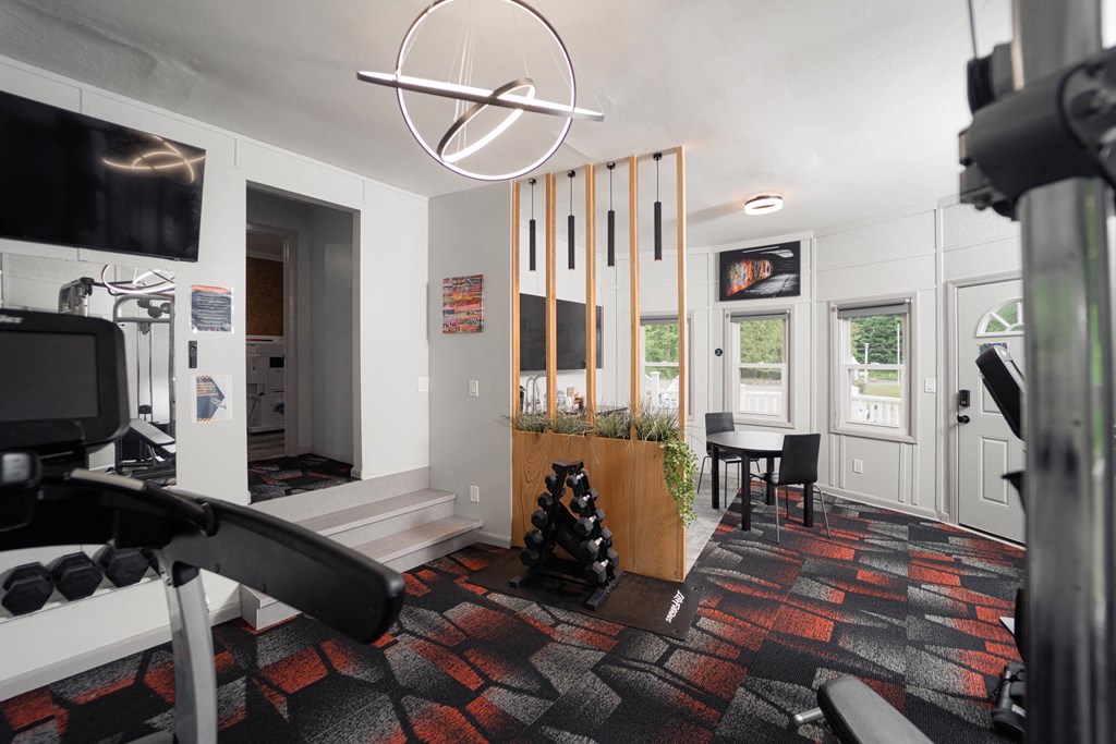 a living room that has a gym and a dining area with a table and chairs at Woodbury, Woodbury, 06798