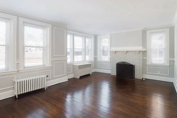 a living room with a wood floor and a fireplace at The Packard, West Hartford, Connecticut, 06119
