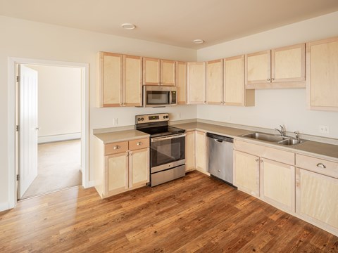 A kitchen with wooden cabinets and stainless steel appliances.