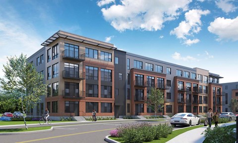 A modern apartment complex with a mix of brick and panel exterior walls.