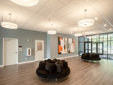 a large room with couches and chairs in the center of it
