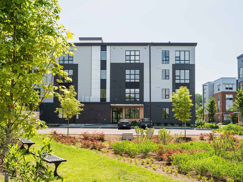 A modern building with a green lawn in front.