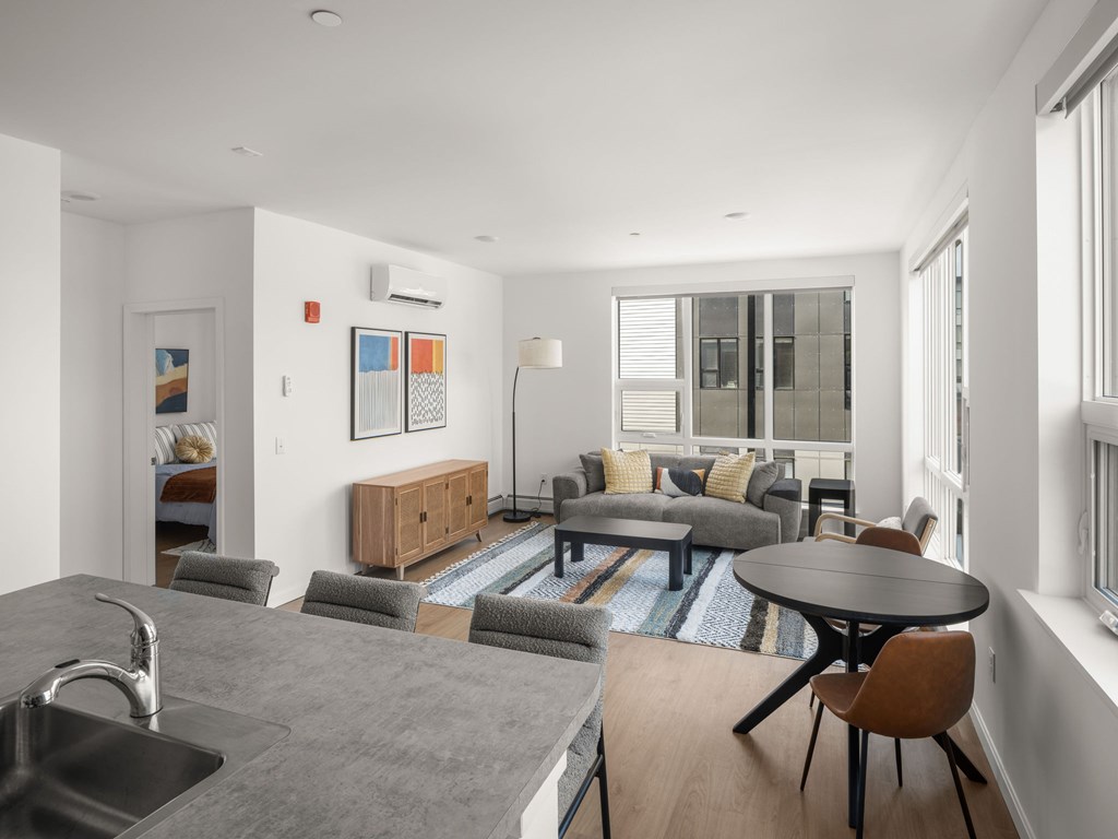 A modern kitchen with a dining table and chairs.