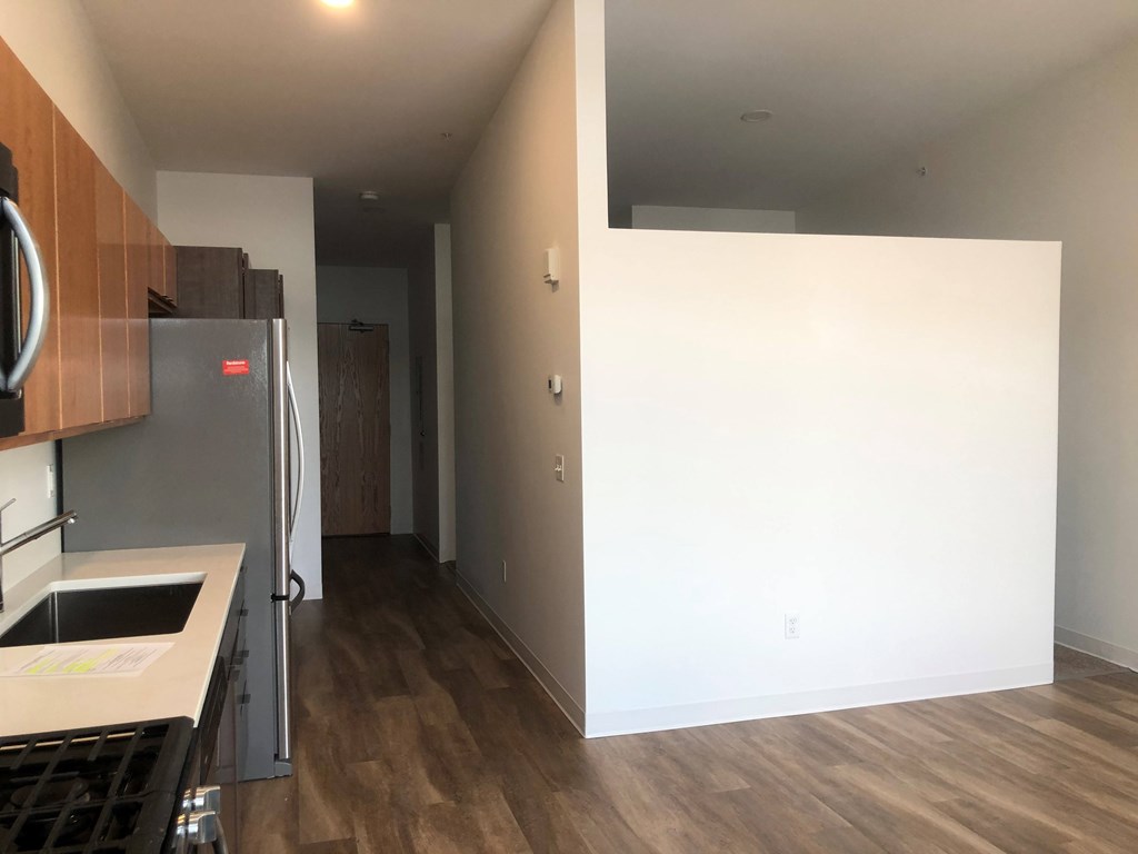 A kitchen with a refrigerator and a countertop.