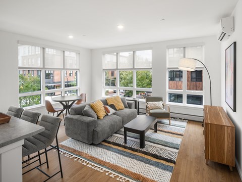 A living room with a grey couch and a coffee table.