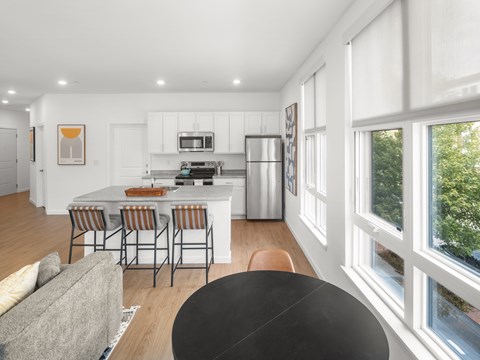 A modern kitchen with a dining table and chairs.