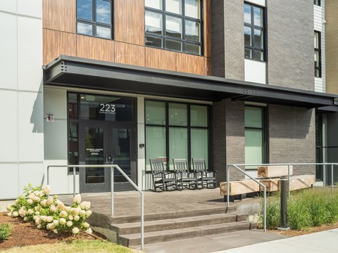 A modern building with a glass door and a number 223 on it.