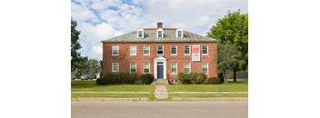 A red brick building with a sign on the front.