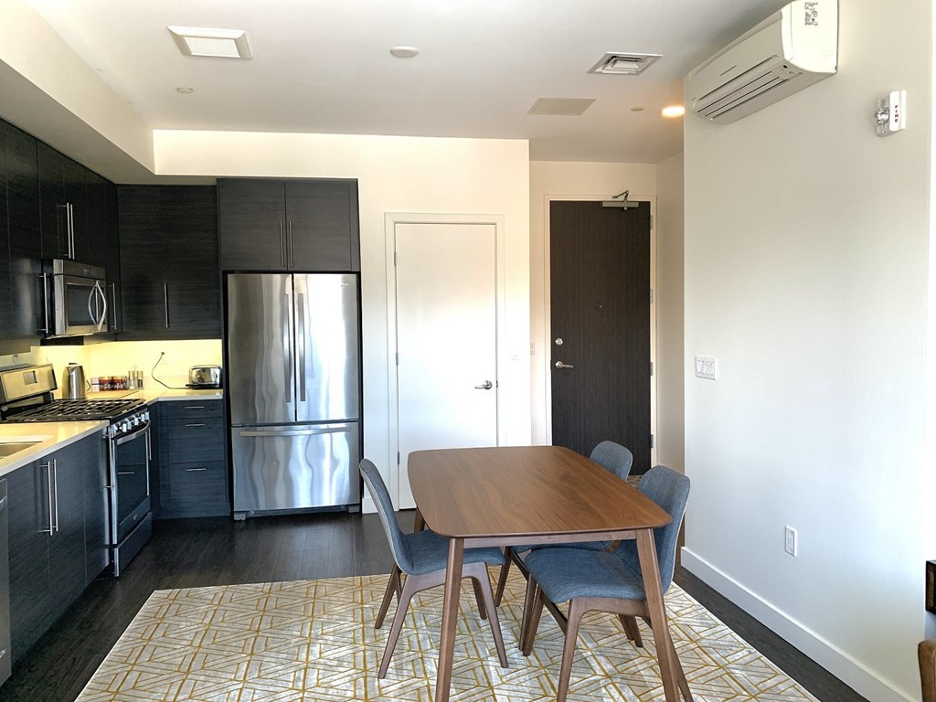 A kitchen with a refrigerator, stove, and oven.